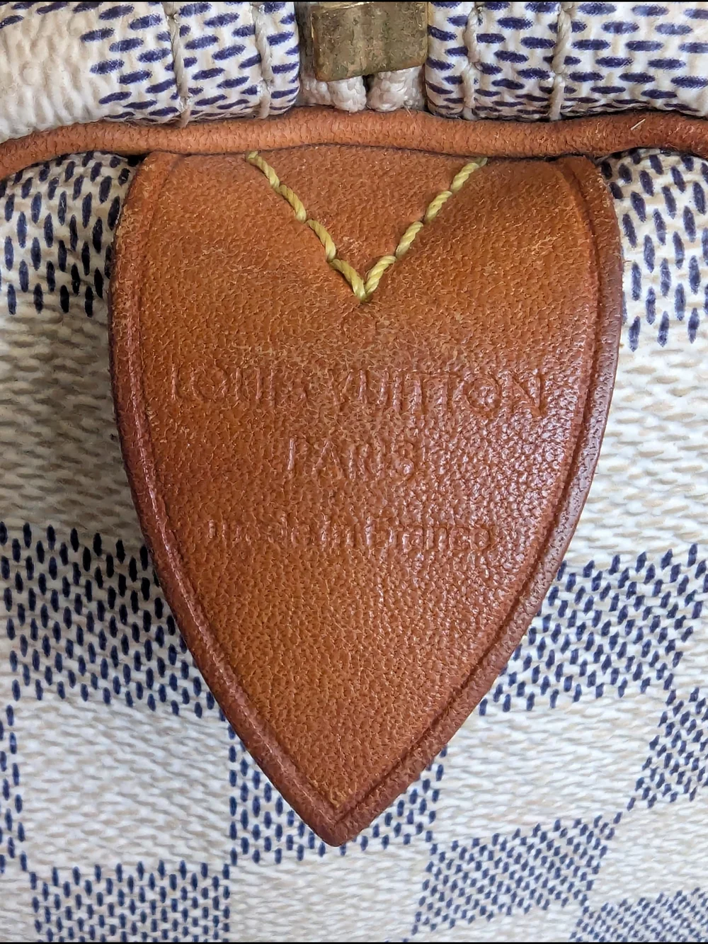 Louis Vuitton Speedyhandbag styled in the iconic Damier Azur canvas pattern.